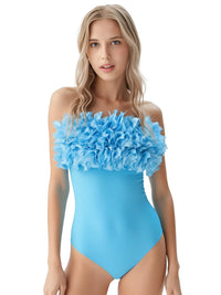 Thumbnail for Woman wearing a blue one-piece swimsuit with ruffled top on a white background