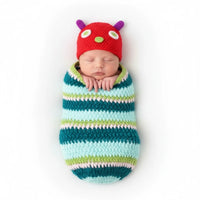 Thumbnail for Newborn baby wrapped in a striped swaddle with a colorful hat on a white background