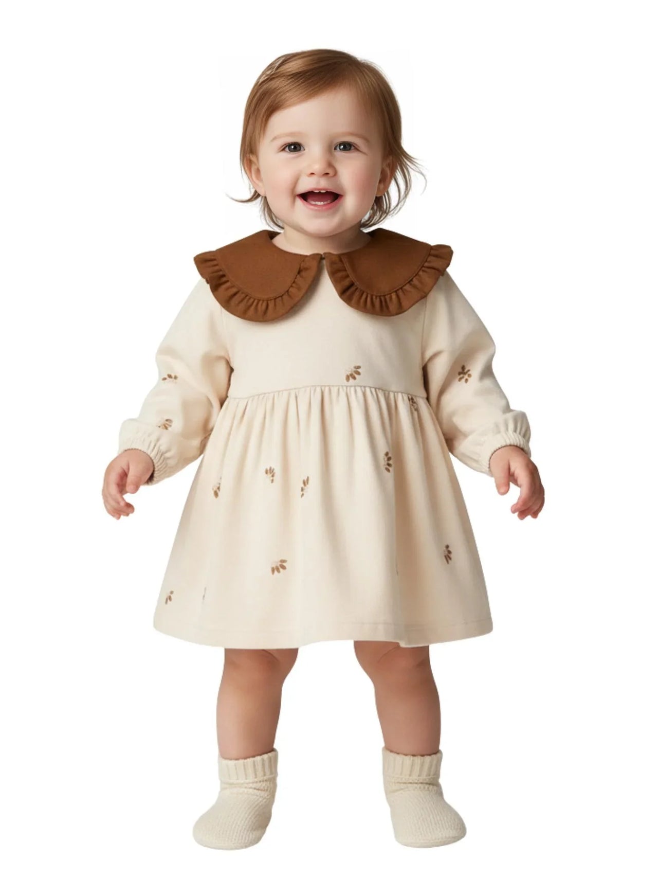 Child wearing a cream dress with a brown collar on a white background