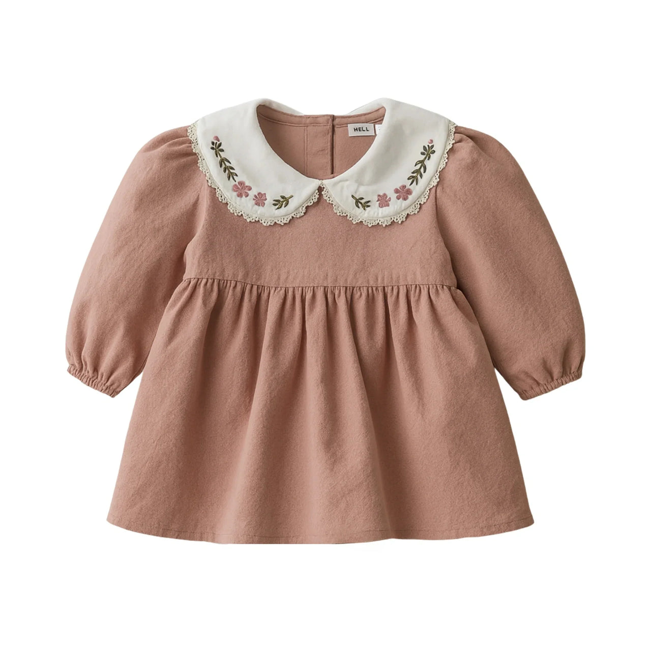 Pink dress with embroidered white collar on a white background