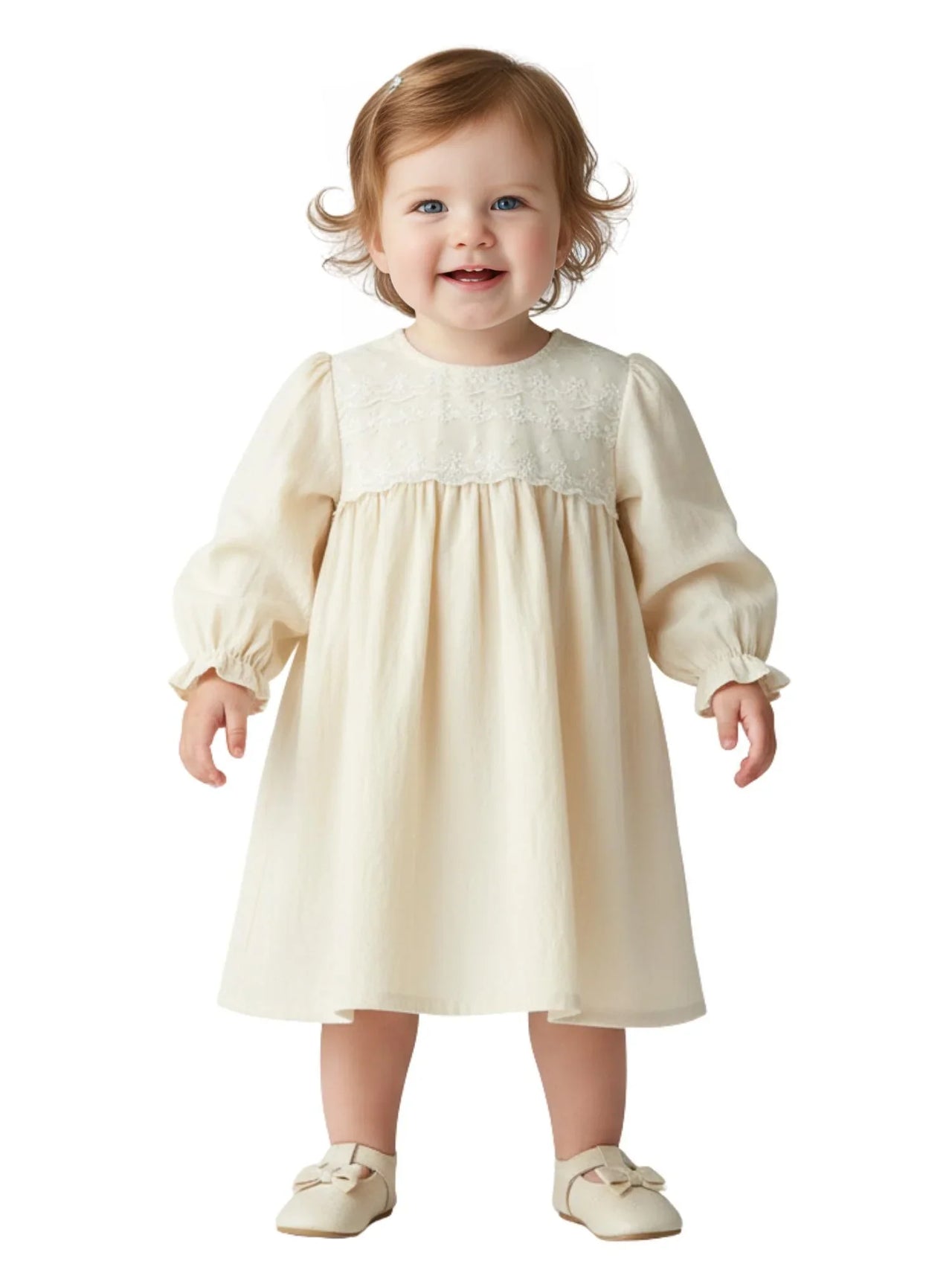 Young child wearing a white dress on a white background