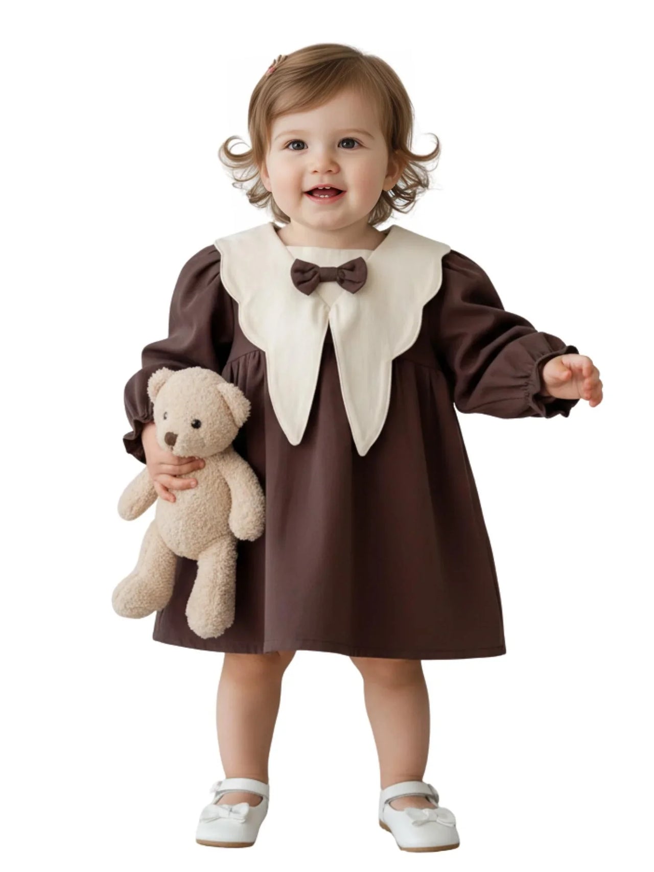 Child wearing a brown dress with a white doll collar holding a teddy bear on a white background