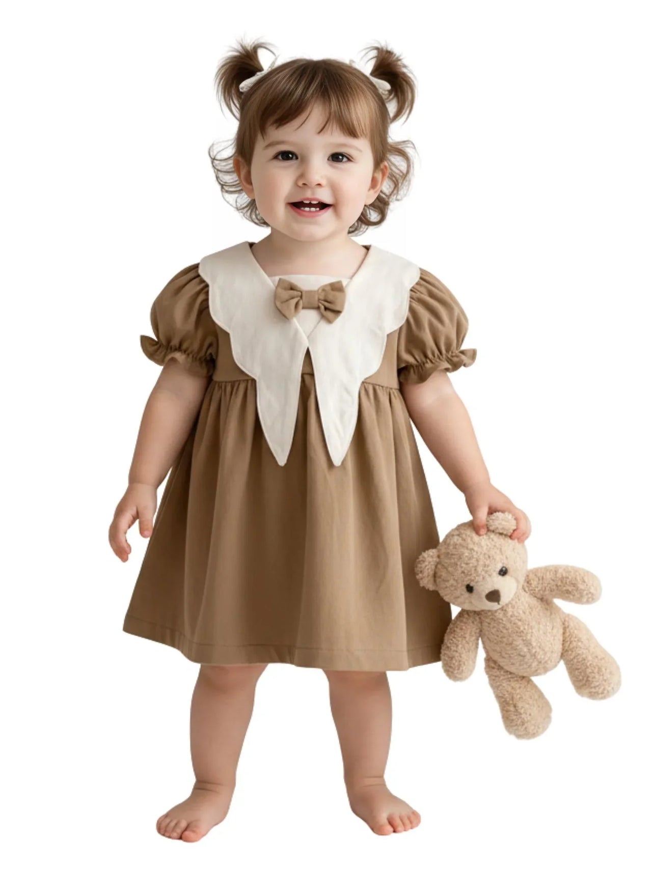 Child wearing a brown dress with a white collar holding a teddy bear on a white background