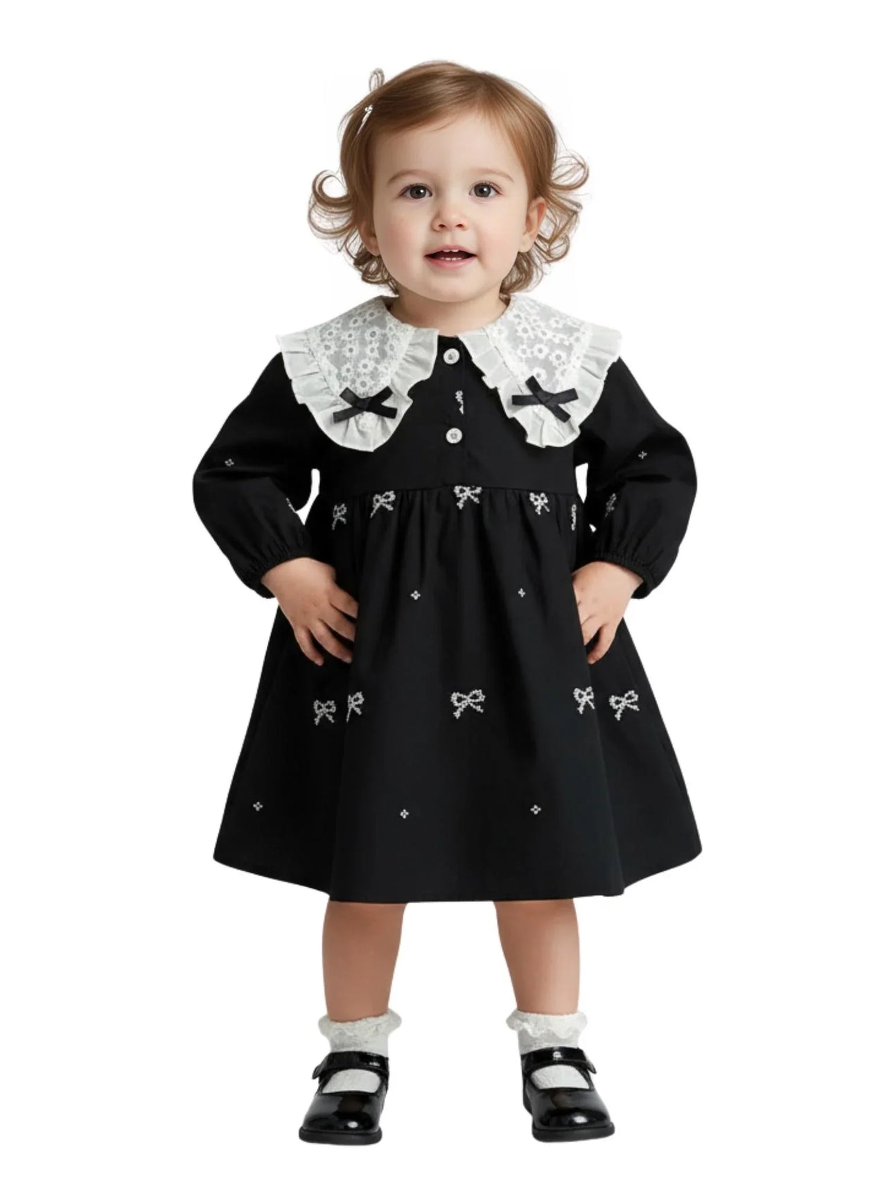 Child wearing a black dress with white collar and bow details on a white background