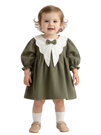 Thumbnail for Child wearing a green dress with a white collar and bow tie on a white background