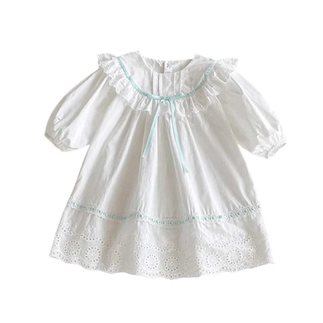 White blouse with green trim on a white background