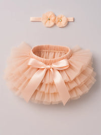 Thumbnail for Peach tutu skirt with a bow and matching headband on a light gray background