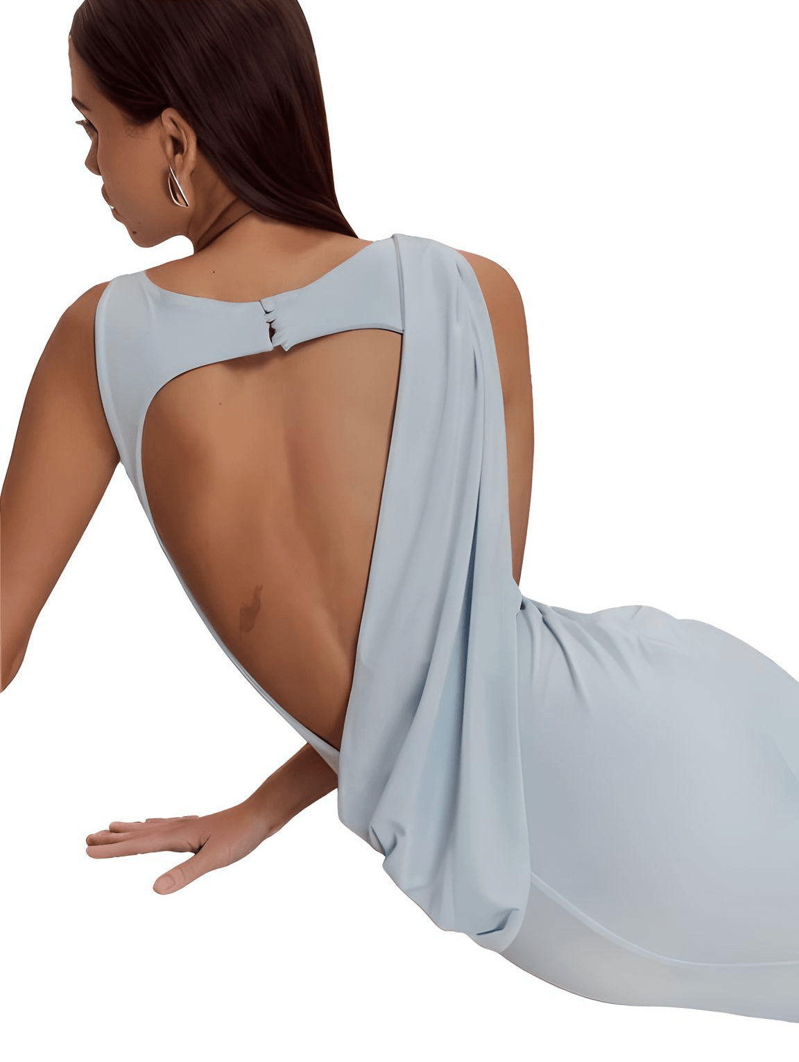 Woman wearing a light blue dress with a flowing design on a white background