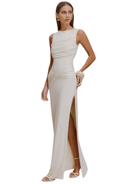 Thumbnail for Woman wearing a white sleeveless gown with a high slit on a white background
