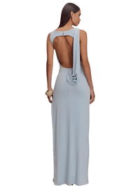 Thumbnail for Woman wearing a light blue evening gown with a backless design on a white background