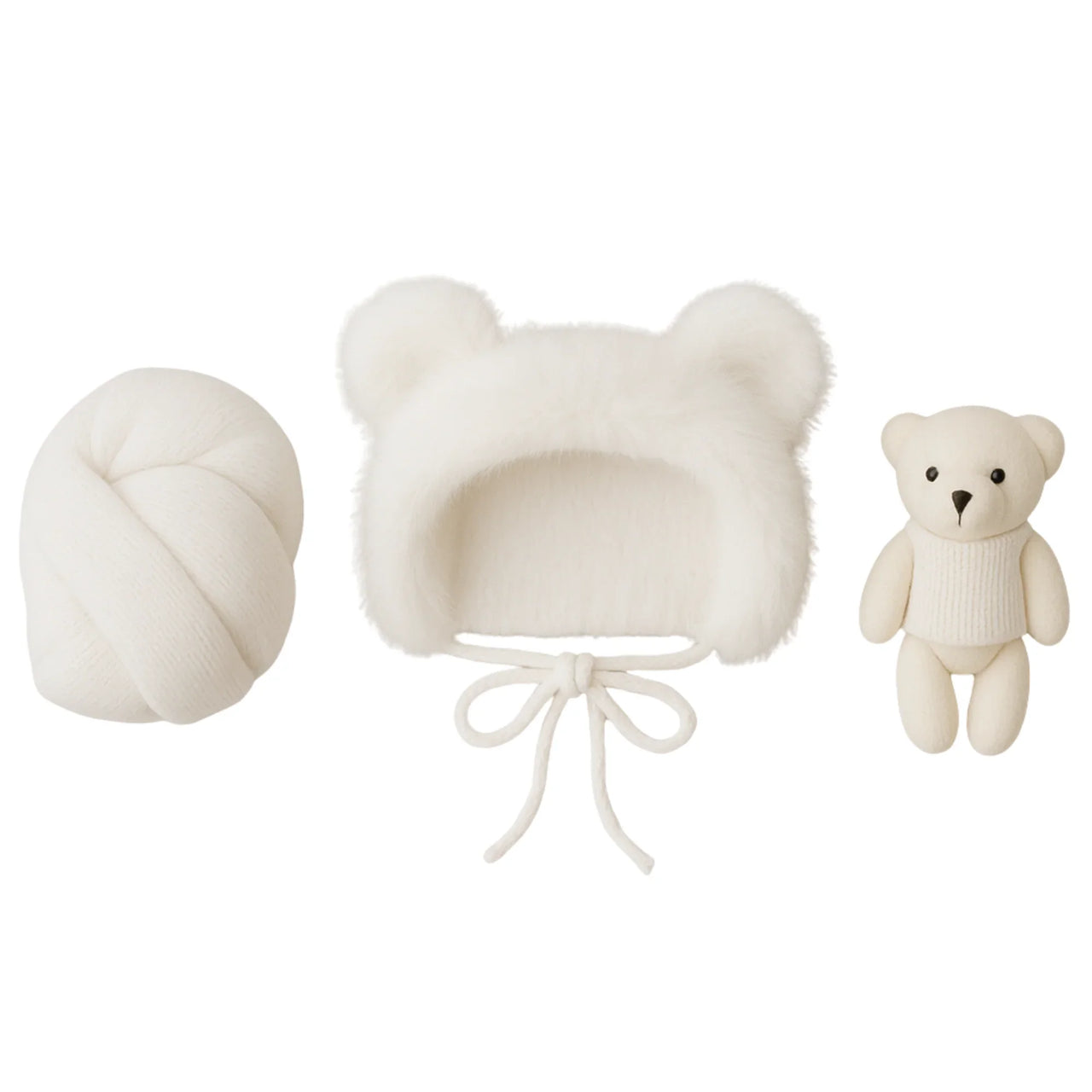 Set of white baby hat, newborn wrap, and teddy bear on a white background