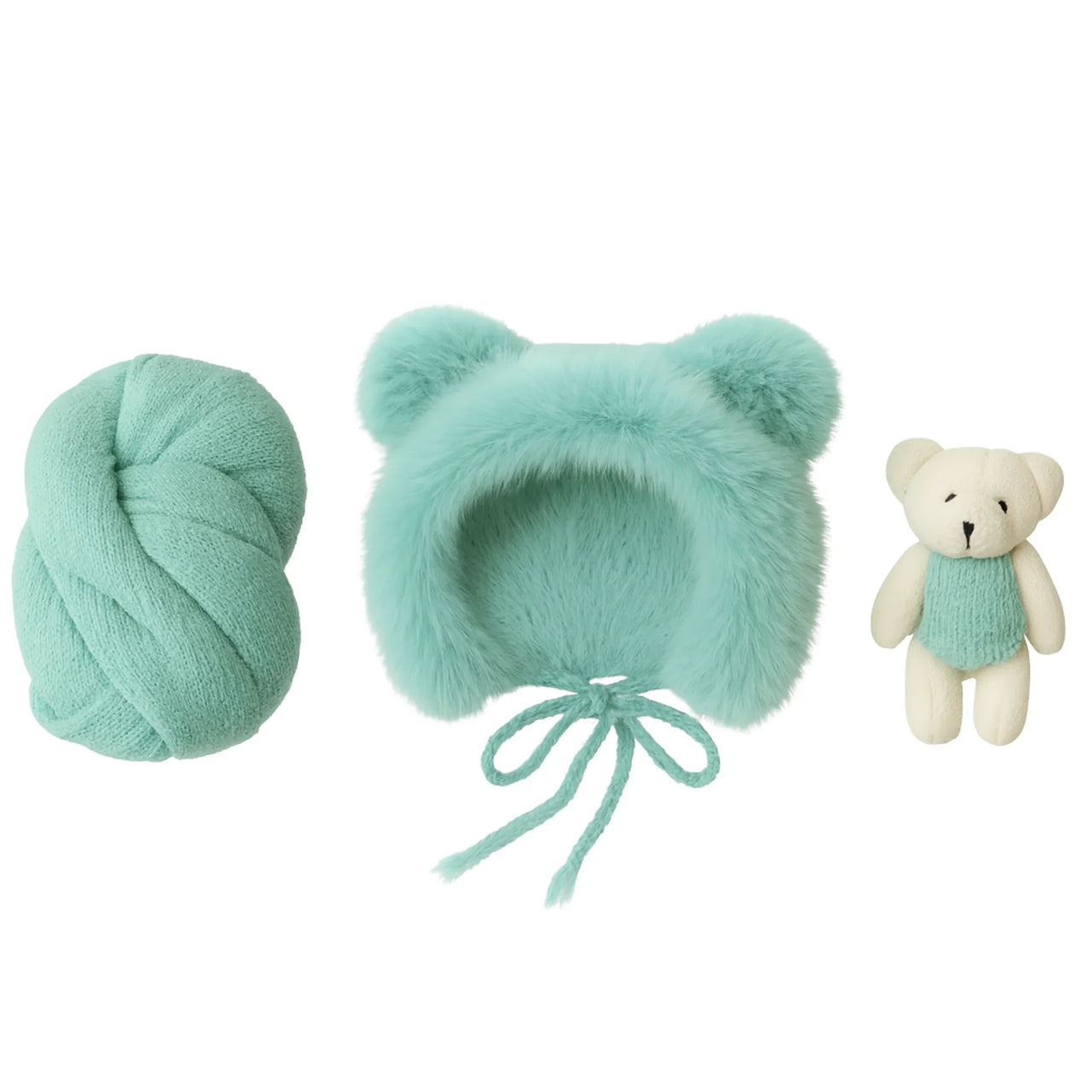Set of green baby hat, newborn wrap, and teddy bear on a white background