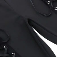 Thumbnail for Close-up of black fabric with leather straps and metal hooks on a dark background