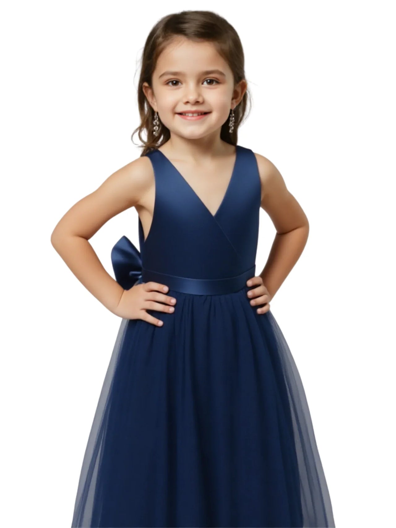 Young girl wearing a navy blue dress with a bow on a white background