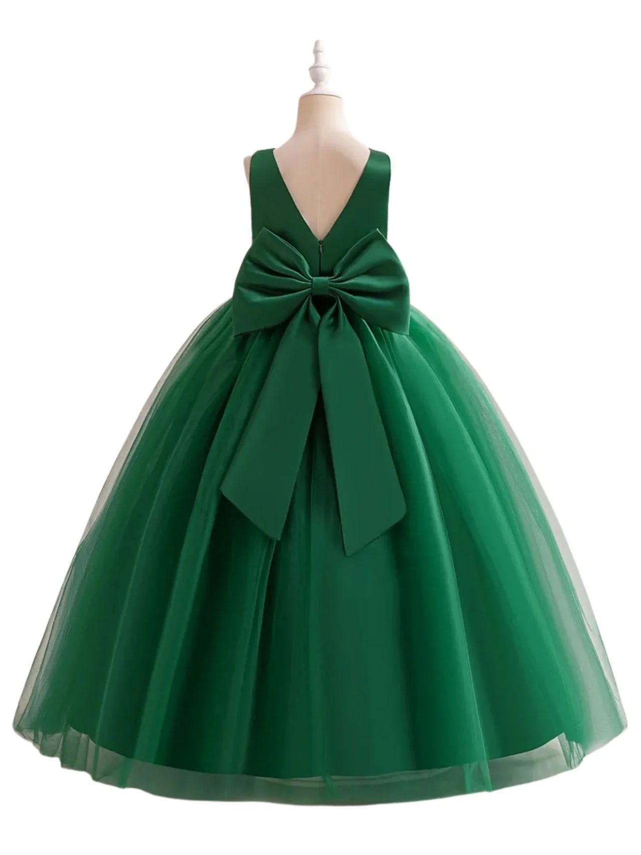 Green dress with a large bow on a mannequin against a white background