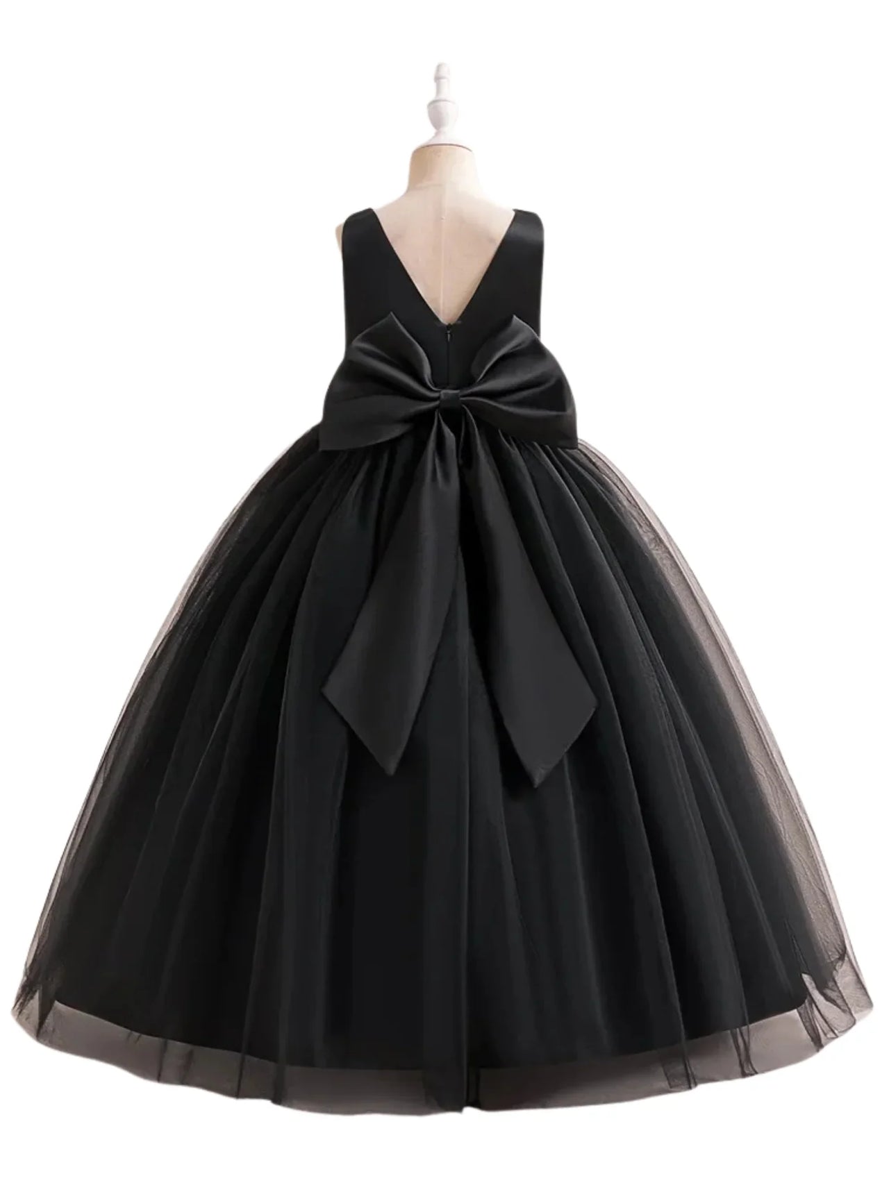 Black dress with a large bow on a mannequin against a white background