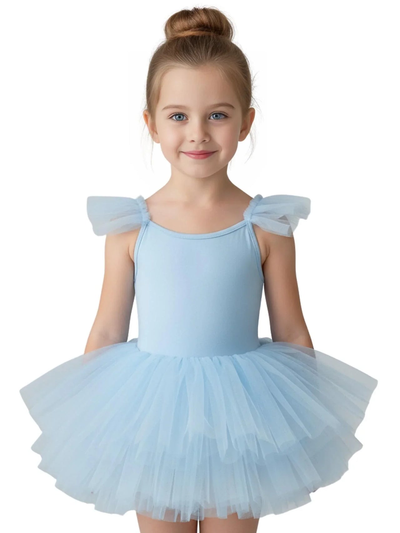 Young girl wearing a light blue ballet tutu dress with pom pom sleeves on a white background