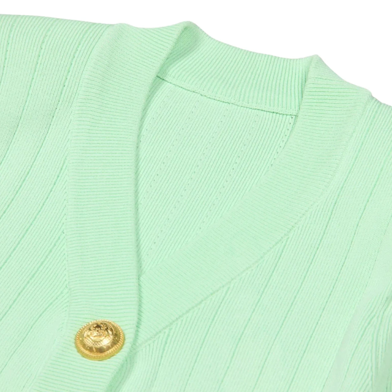 Light green cardigan with a gold button on a white background