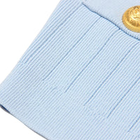 Thumbnail for Close-up of a light blue uniform patch with a gold button on a white background