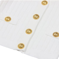 Thumbnail for Close-up of a white garment with gold buttons