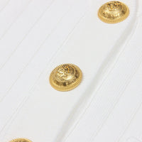 Thumbnail for Gold buttons on a white textured fabric background