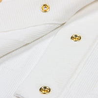 Thumbnail for Close-up of a white fabric with gold buttons