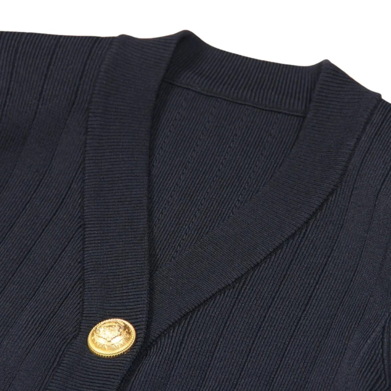 Navy blue cardigan with a gold button on a white background
