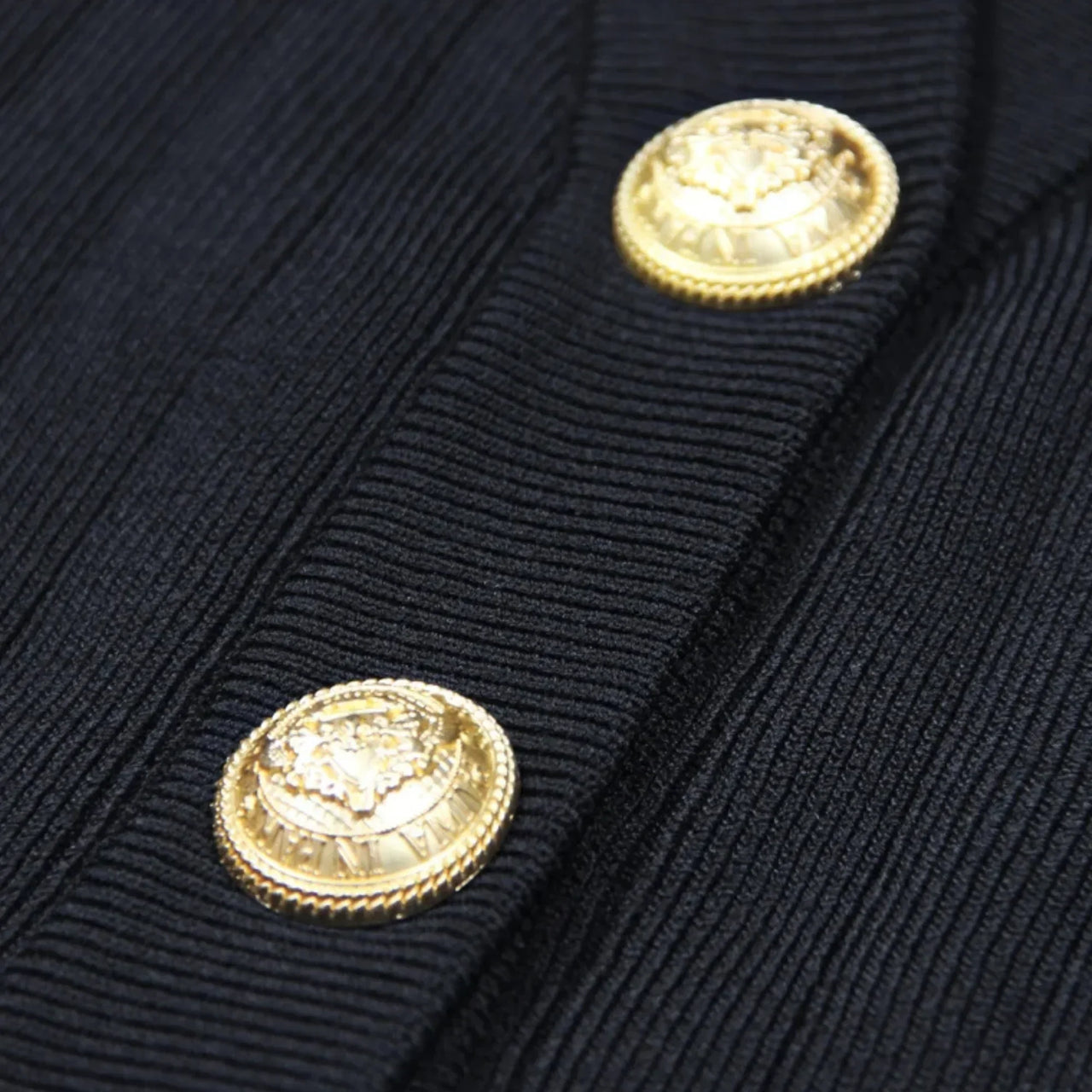 Close-up of a navy blue jacket with gold buttons