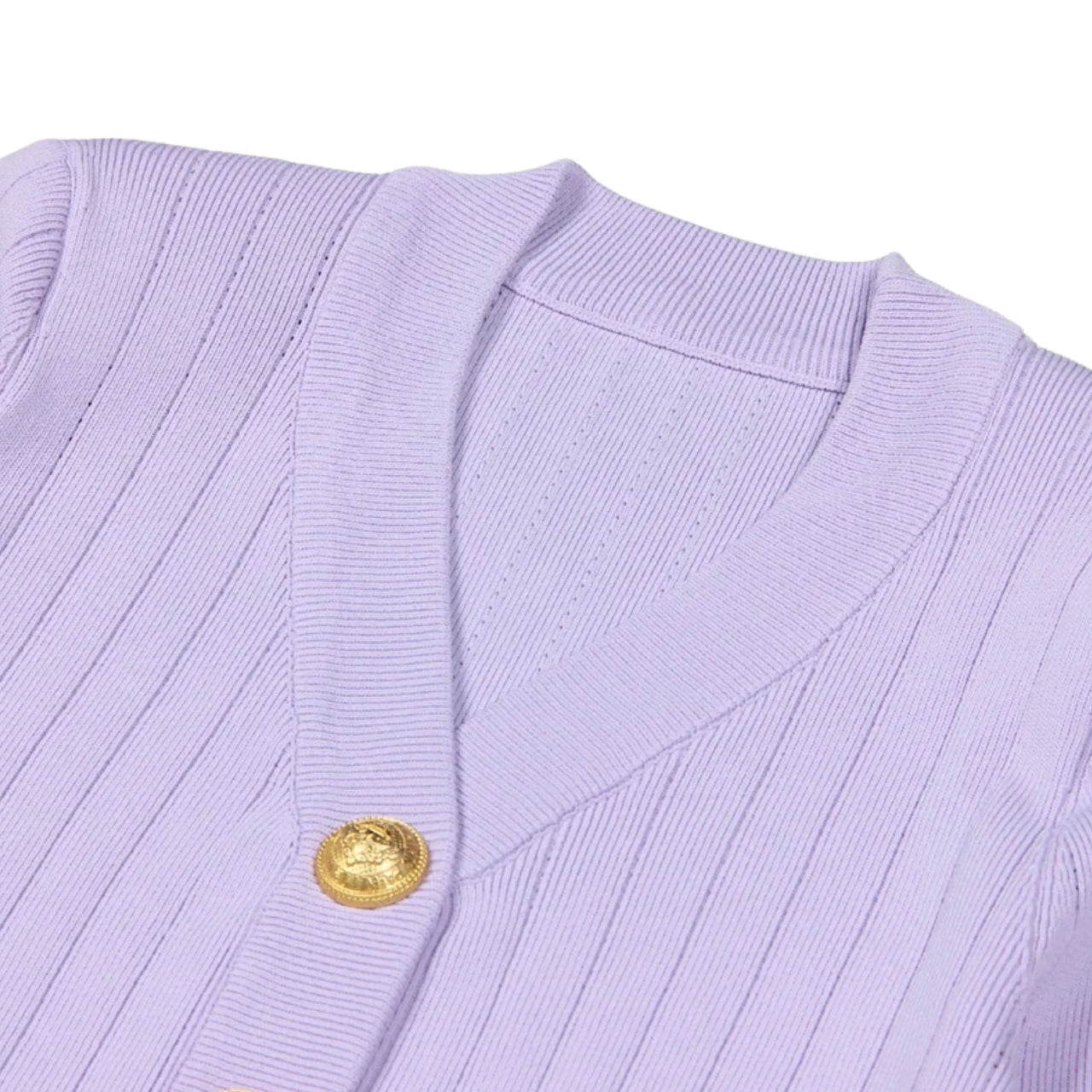 Close-up of a light purple cardigan with a gold button on a white background
