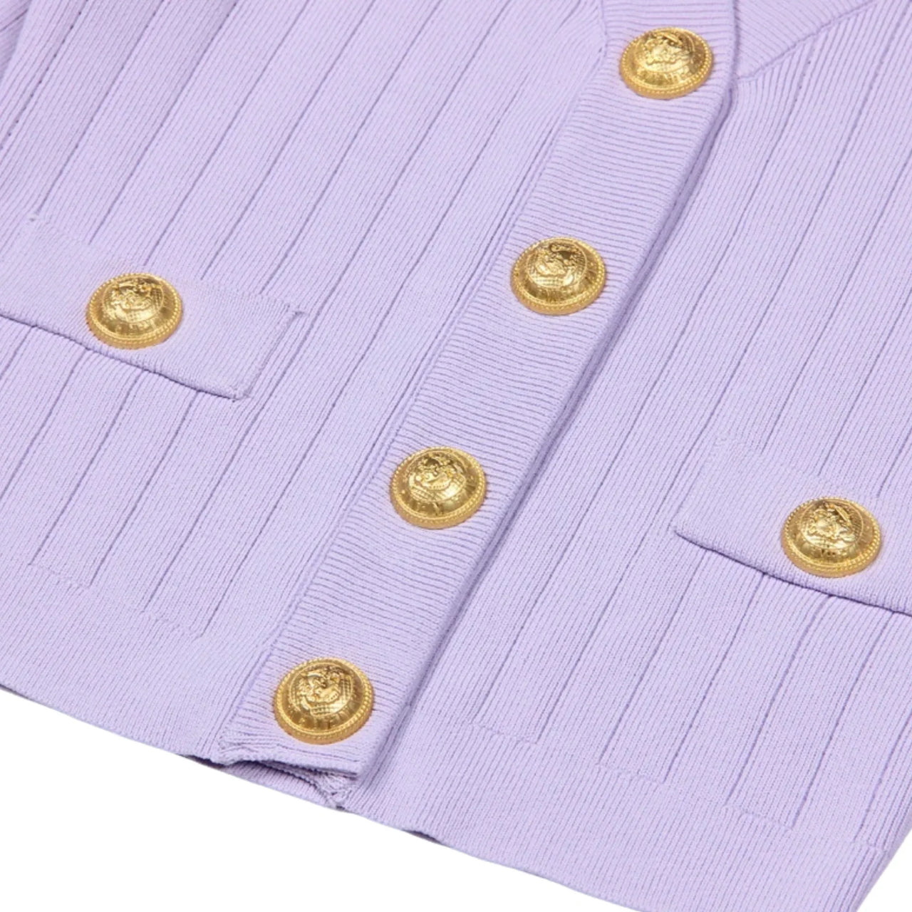 Close-up of a light purple cardigan with a gold button on a white background