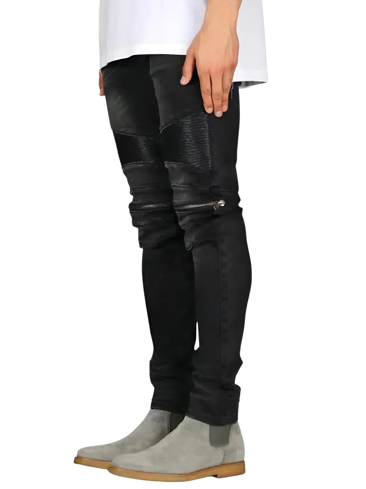 Person wearing black denim and leather jeans on a white background