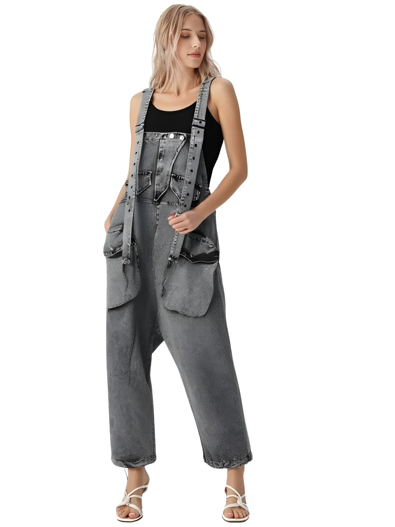 Woman wearing black denim overalls on a white background