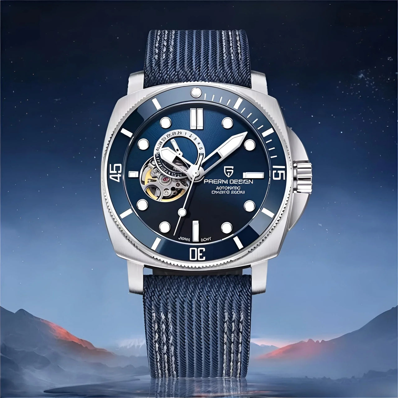 Luxury watch with blue strap and dark blue dial against a mountainous landscape background