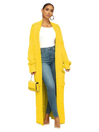 Thumbnail for Woman wearing a long yellow cardigan with a white top and blue jeans on a white background