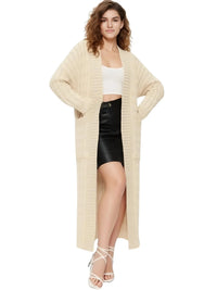Thumbnail for Woman wearing a long beige cardigan over a white top and black skirt on a white background