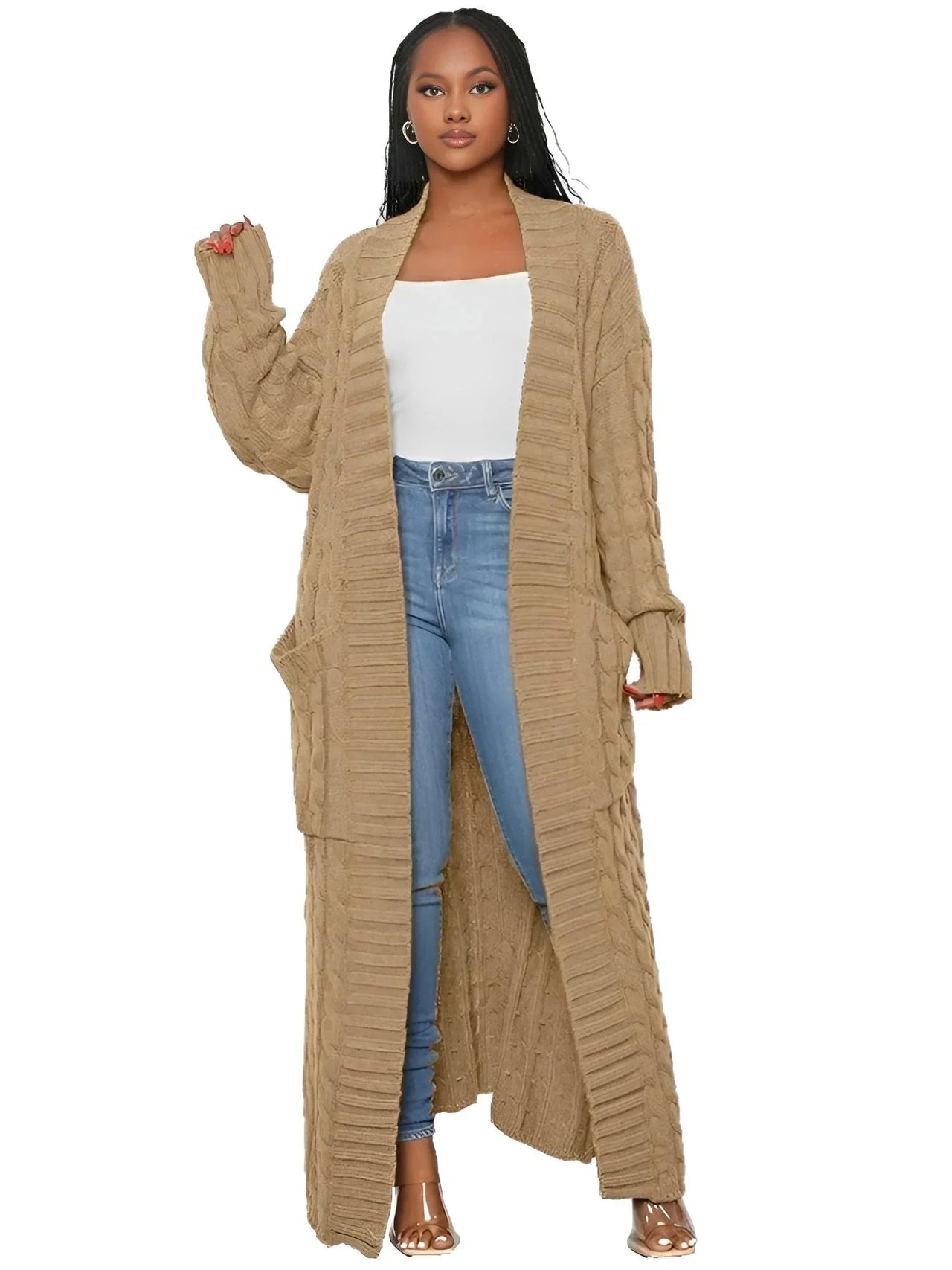 Woman wearing a long light browm cardigan over a white top and blue jeans on a white background