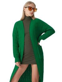 Thumbnail for Woman wearing a long green cardigan over a green dress with sunglasses on a white background