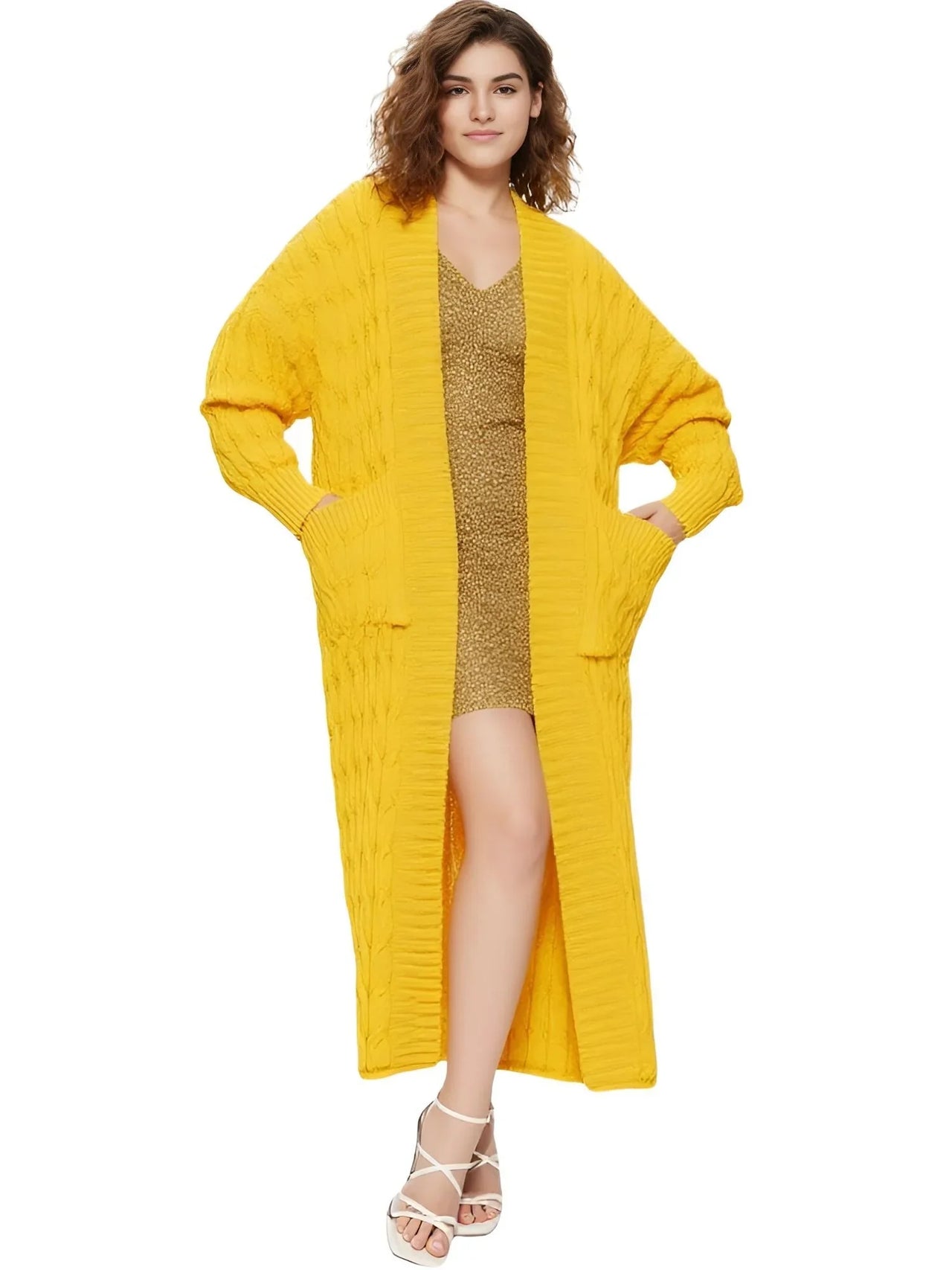 Woman wearing a long yellow cardigan over a gold dress on a white background