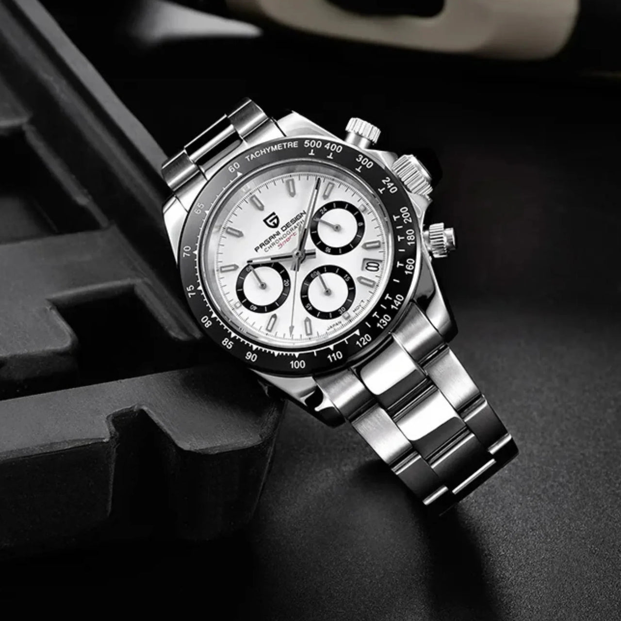 Silver wristwatch with a detailed white face on a dark background