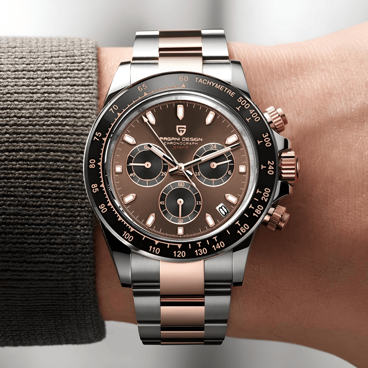 Luxury watch with brown dial and rose gold accents on a wrist.