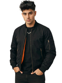 Thumbnail for Man wearing a black bomber jacket with orange lining and with sunglasses on his head against a white background