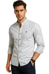 Thumbnail for Man wearing a light gray button-up shirt with a white background