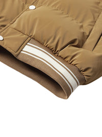 Thumbnail for Close-up of a brown puffer jacket with white buttons and trim on a white background