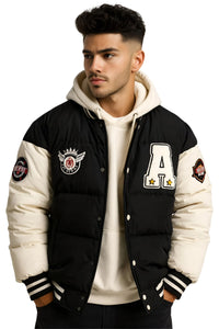 Thumbnail for Man wearing a black and white hooded varsity jacket with patches on a white background