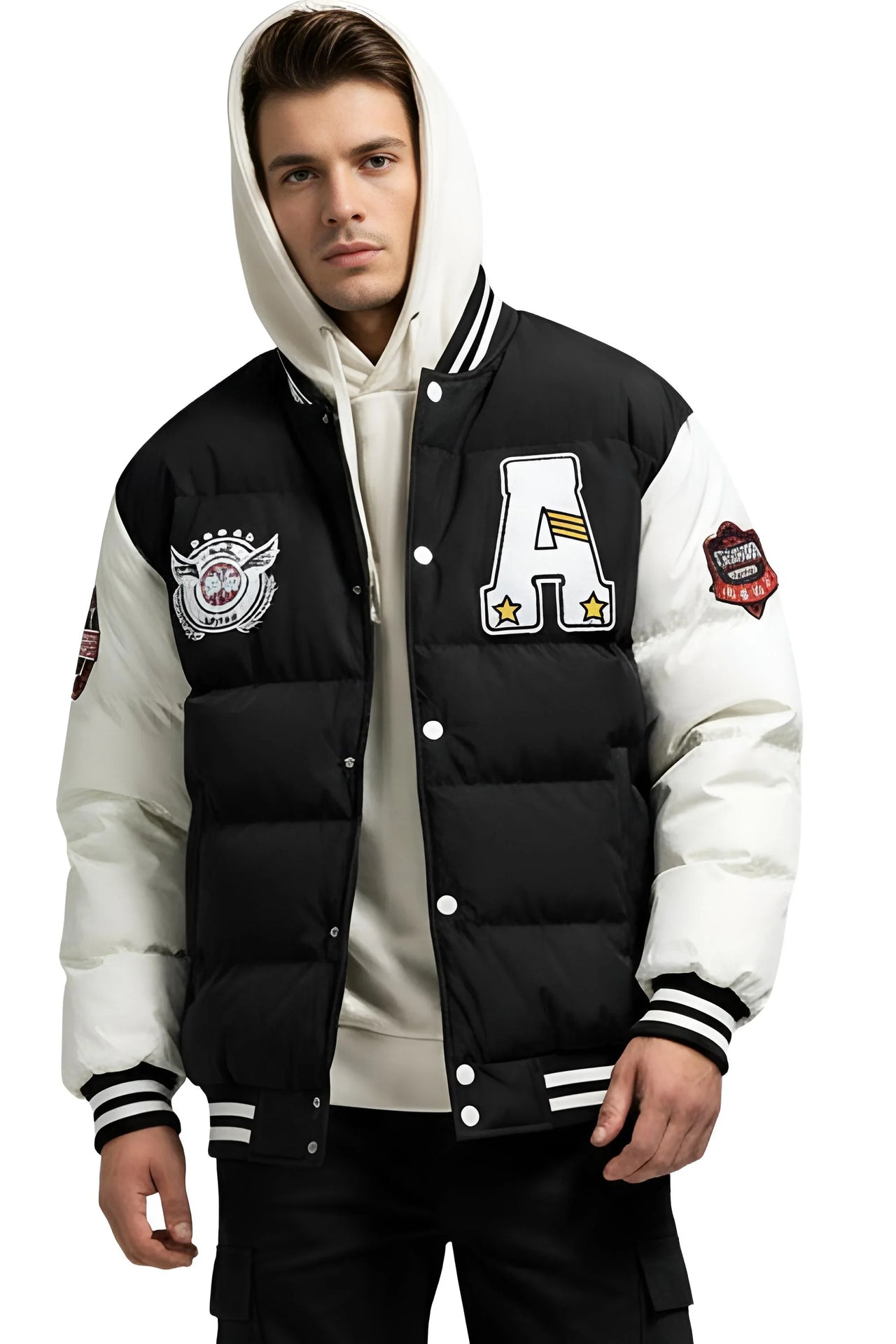 Man wearing a black and white hooded varsity jacket with patches on a white background