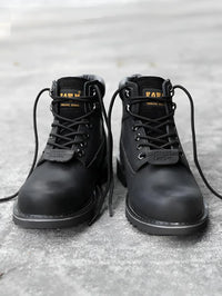 Thumbnail for Pair of black leather boots with laces on a textured surface