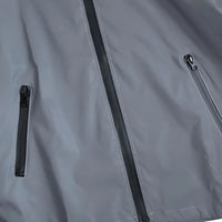 Thumbnail for Close-up of a gray reflective jacket with zippers on a dark background