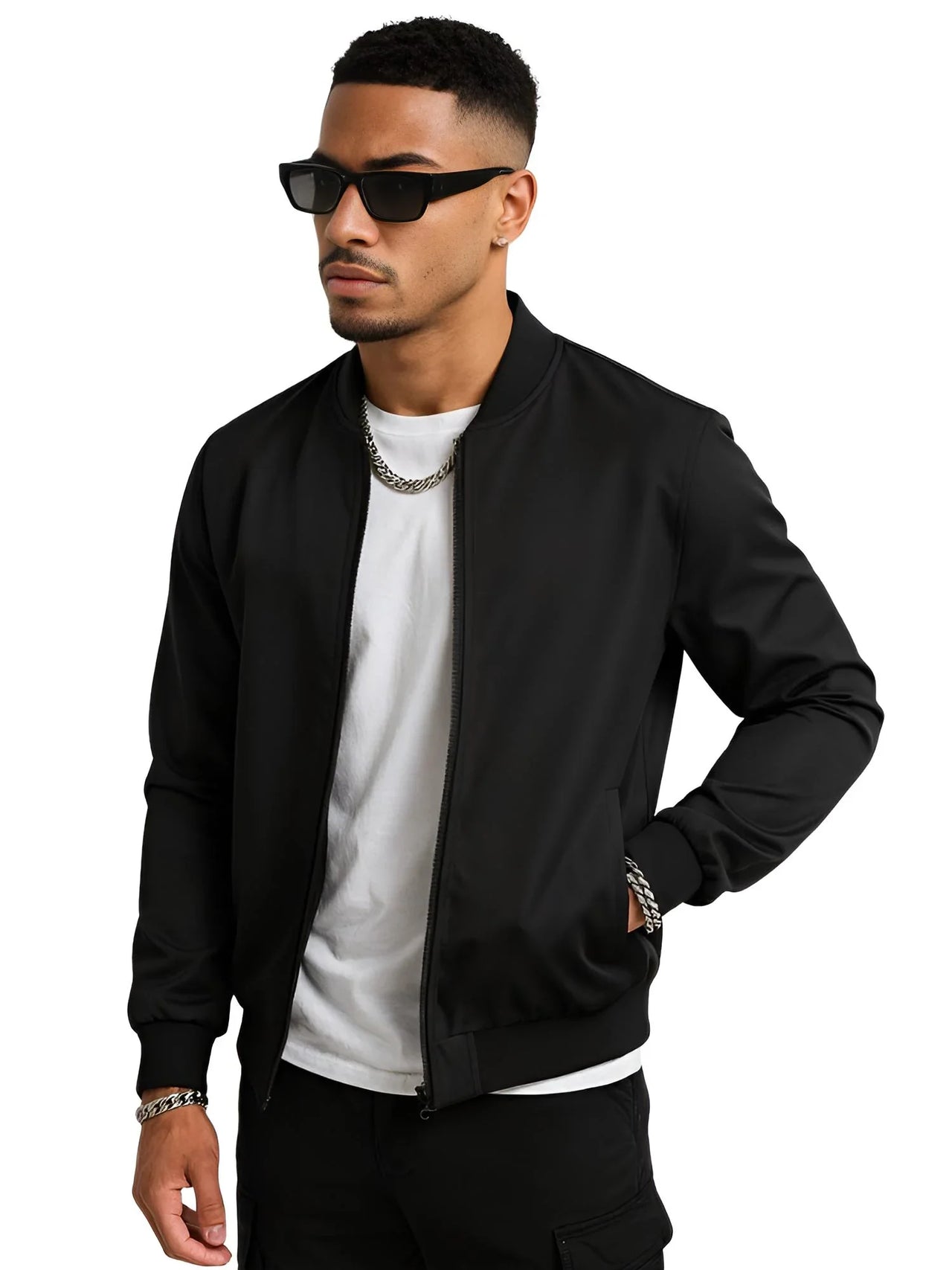 Man wearing a black bomber jacket, white shirt, and sunglasses on a white background