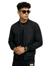 Thumbnail for Man wearing a black bomber jacket and sunglasses on a white background