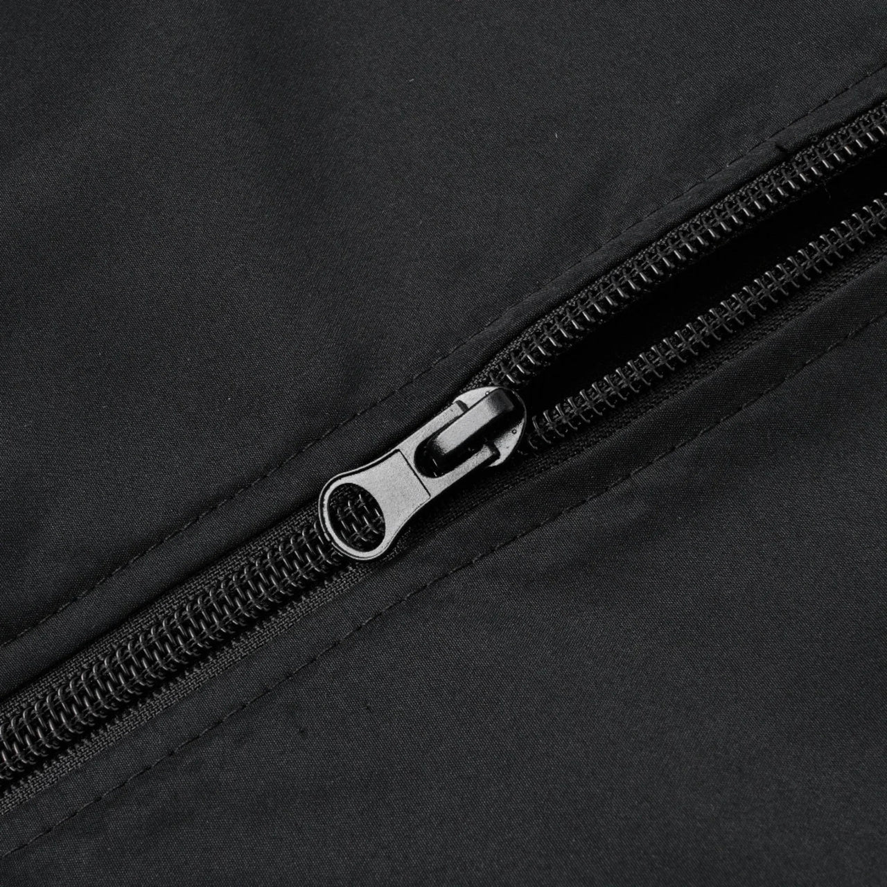 Close-up of a black zipper on a black bomber jacket
